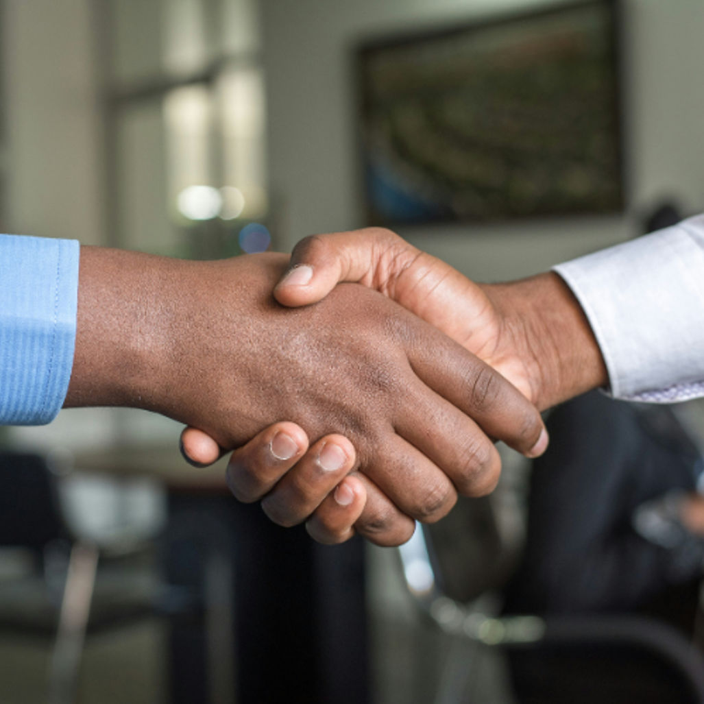 Professional handshake between two businesspeople in office setting