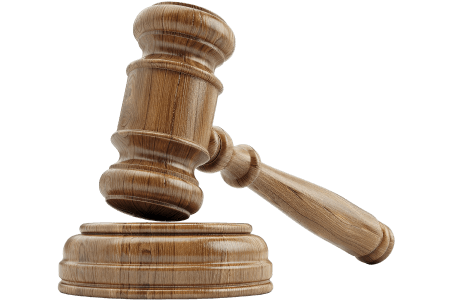 Wooden judge's gavel resting on sound block, legal symbol representing law, justice, and court proceedings.